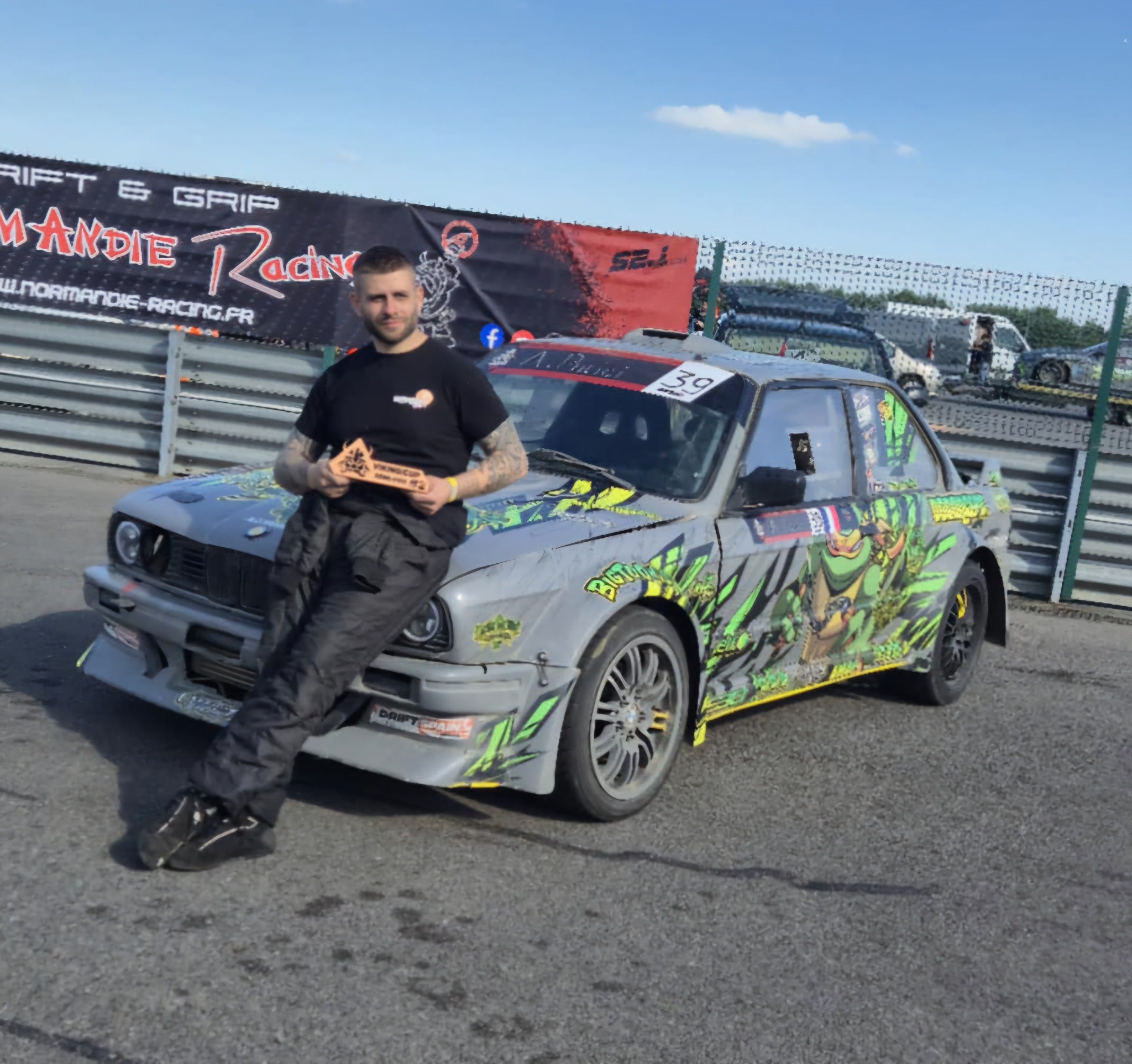 Anthony avec un trophée auprès de sa BMW E30 — photo 2